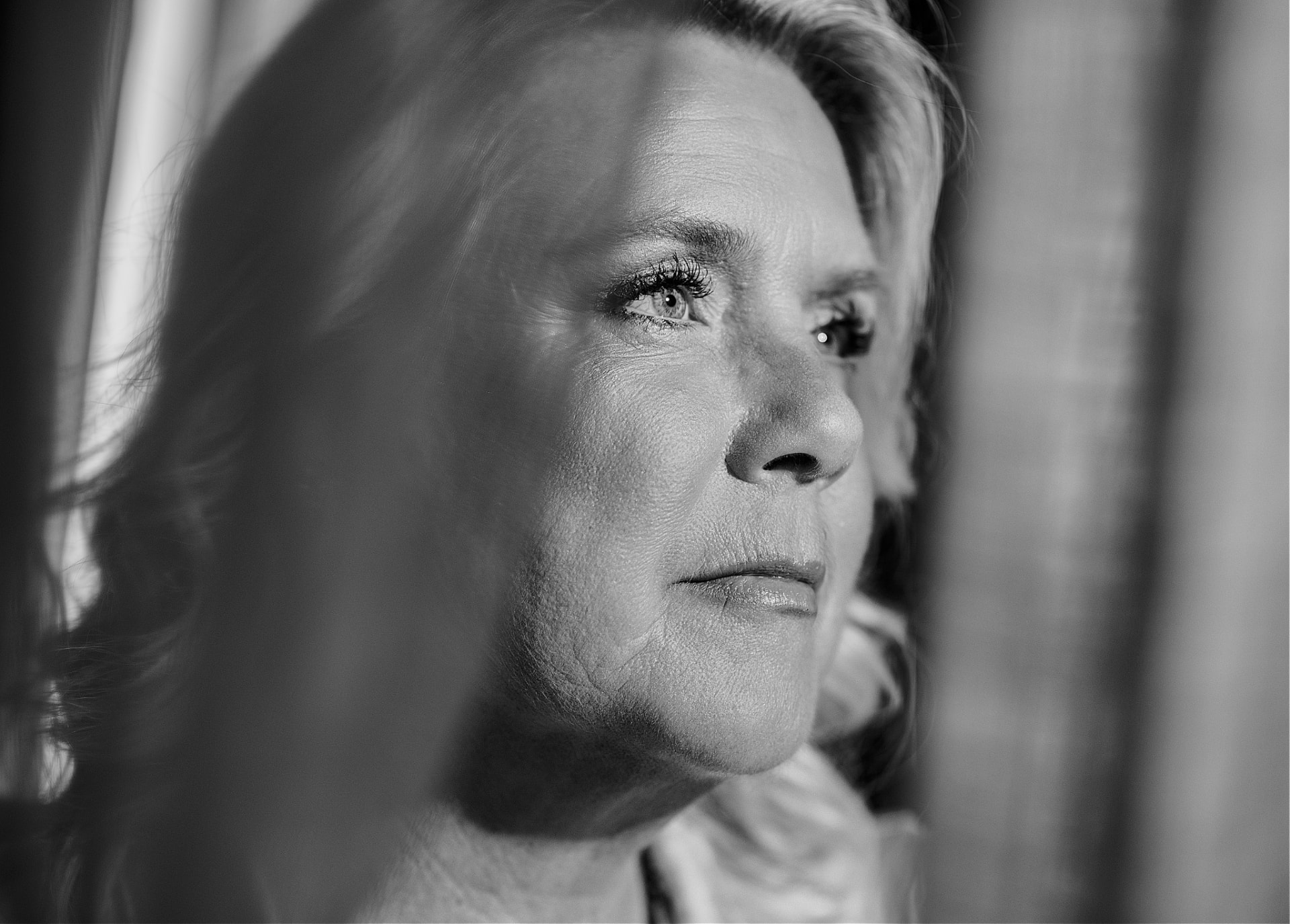 Black and white profile portrait of Camilla looking out of frame